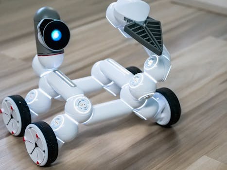 Close-up of a flexible modular robot with wheels on a wooden floor, showcasing modern robotics technology.
