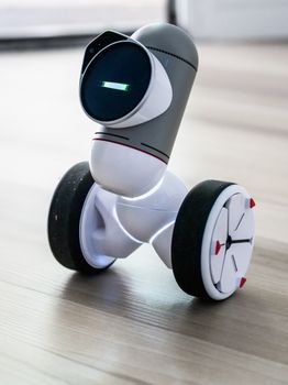 Close-up of a modern robotic device with wheels, showcasing advanced technology.
