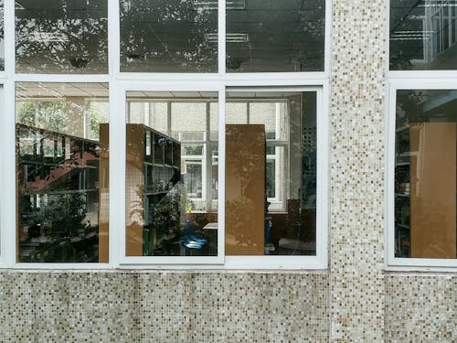 Free stock photo of arched window, book shelves, geometric pattern