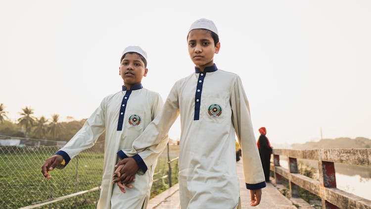 Boys In School Uniforms Holding Hands While Walking