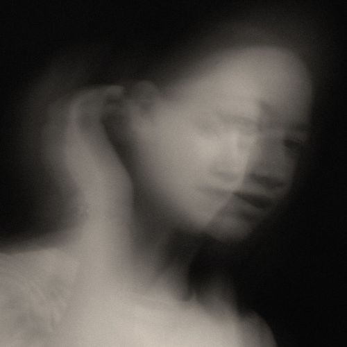 Free Artistic black and white portrait with motion blur, capturing ethereal emotions in a studio setting. Stock Photo