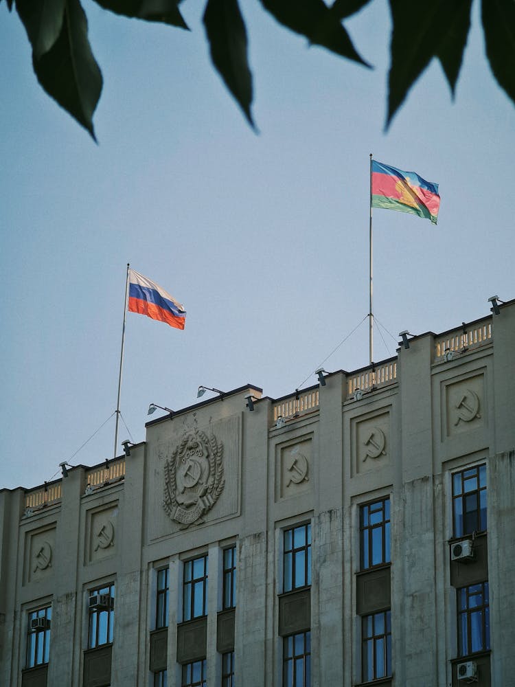 Russian Flags On The Parliament Building In Moscow Against Blue Sky 