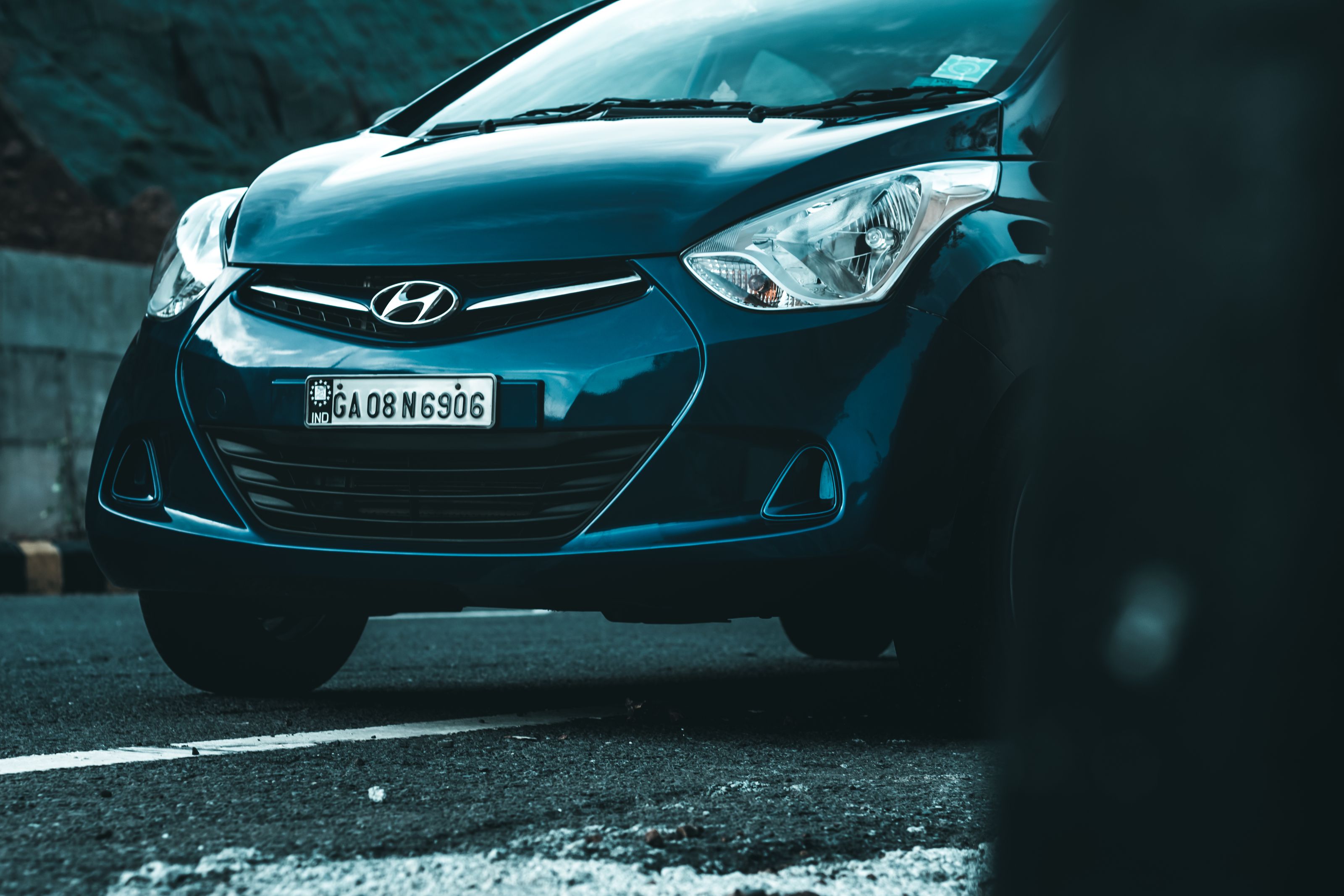 Front view of a Hyundai vehicle parked on an asphalt road.