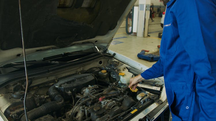 A Mechanic Repairing A Car