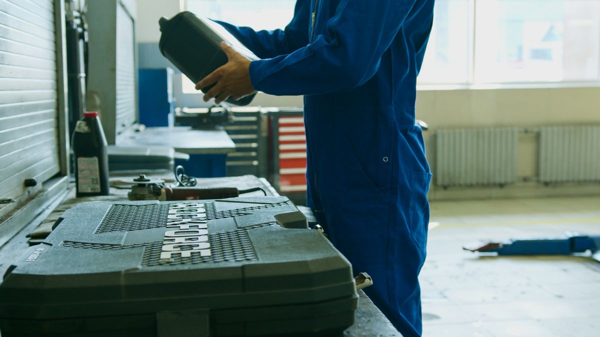 HVAC technician performing maintenance tune-up on air conditioning unit