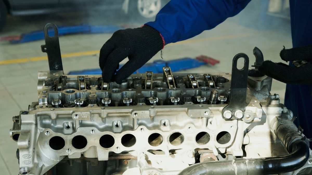 Mechanic inspecting an engine in a workshop