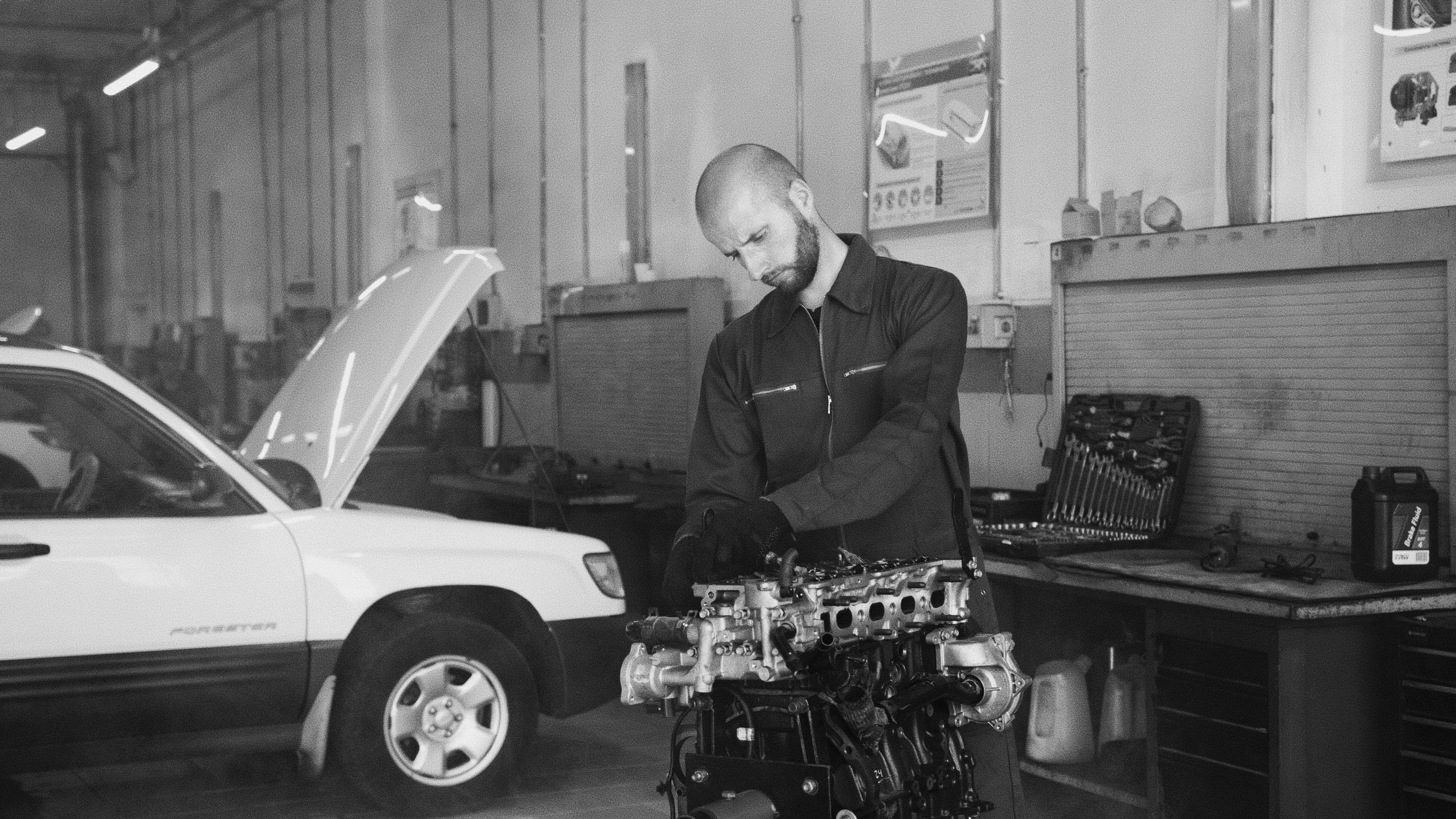 HVAC technician testing thermostat wiring and checking system controls during a home service visit