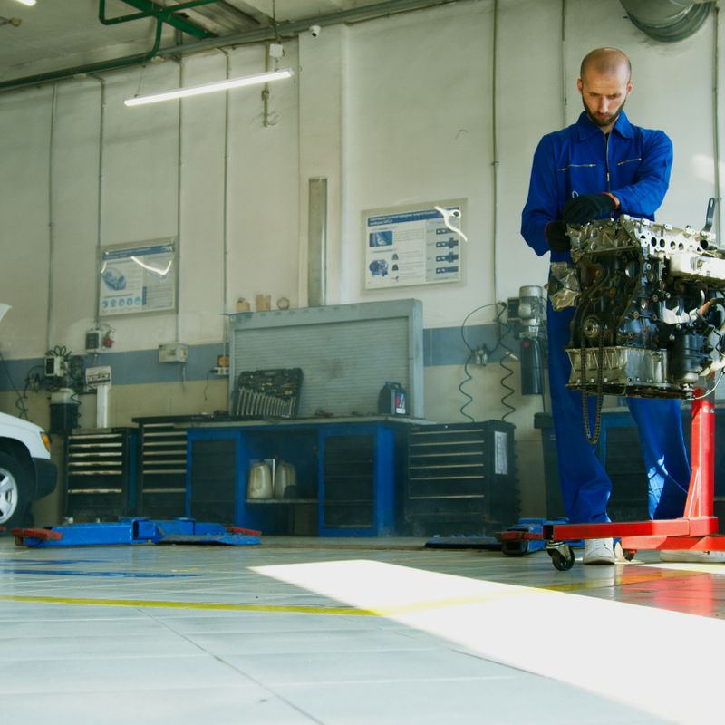 Auto repair technician working on vehicle engine at A1-Automotive