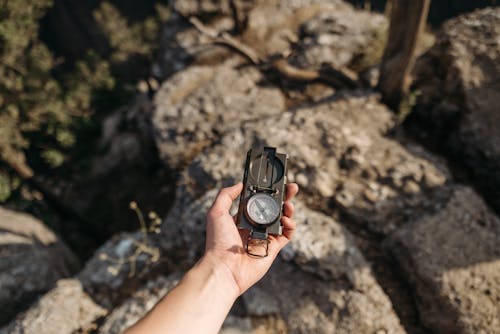 Free Person Holding Black Compass Stock Photo