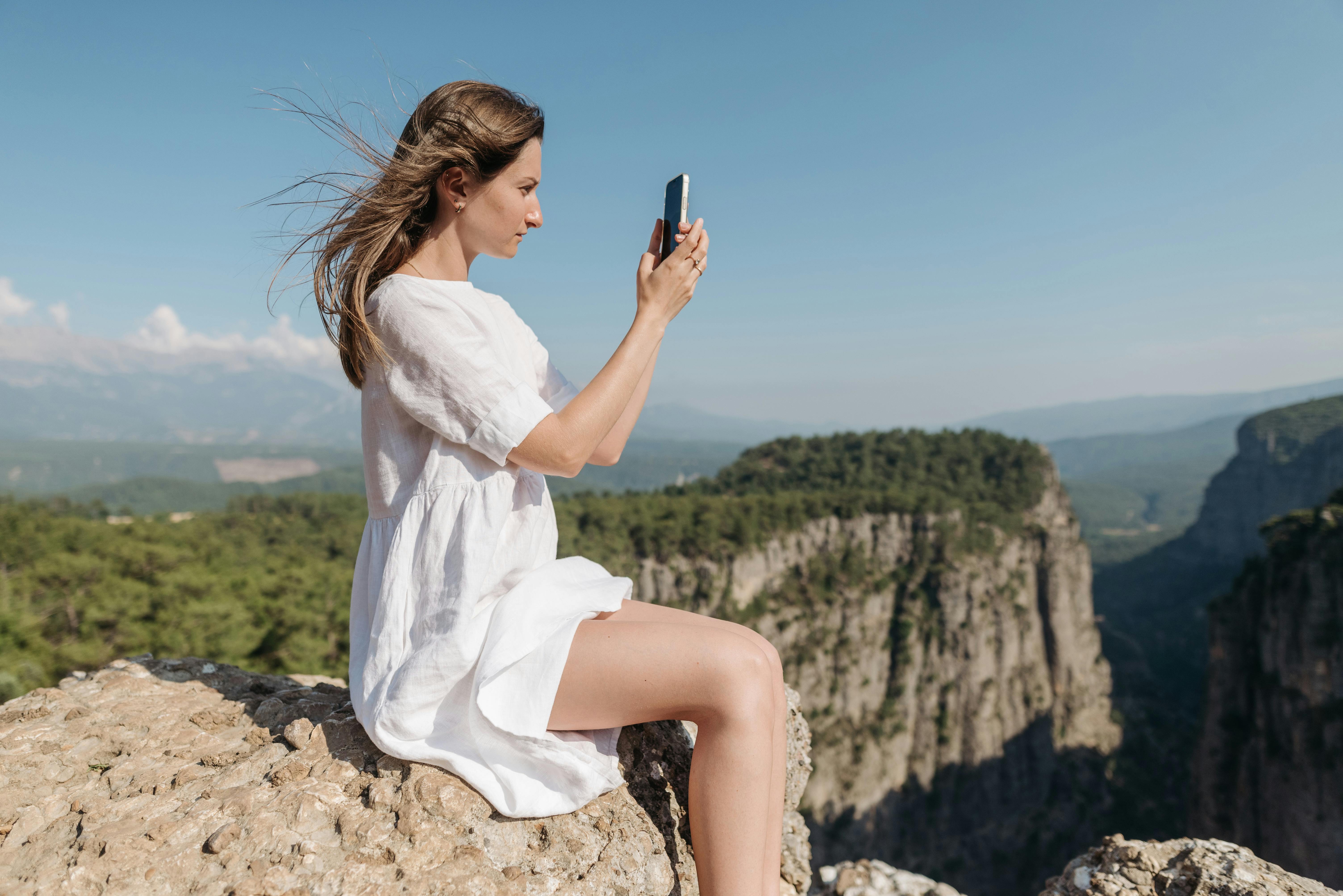 A Woman Sitting on a Cliff