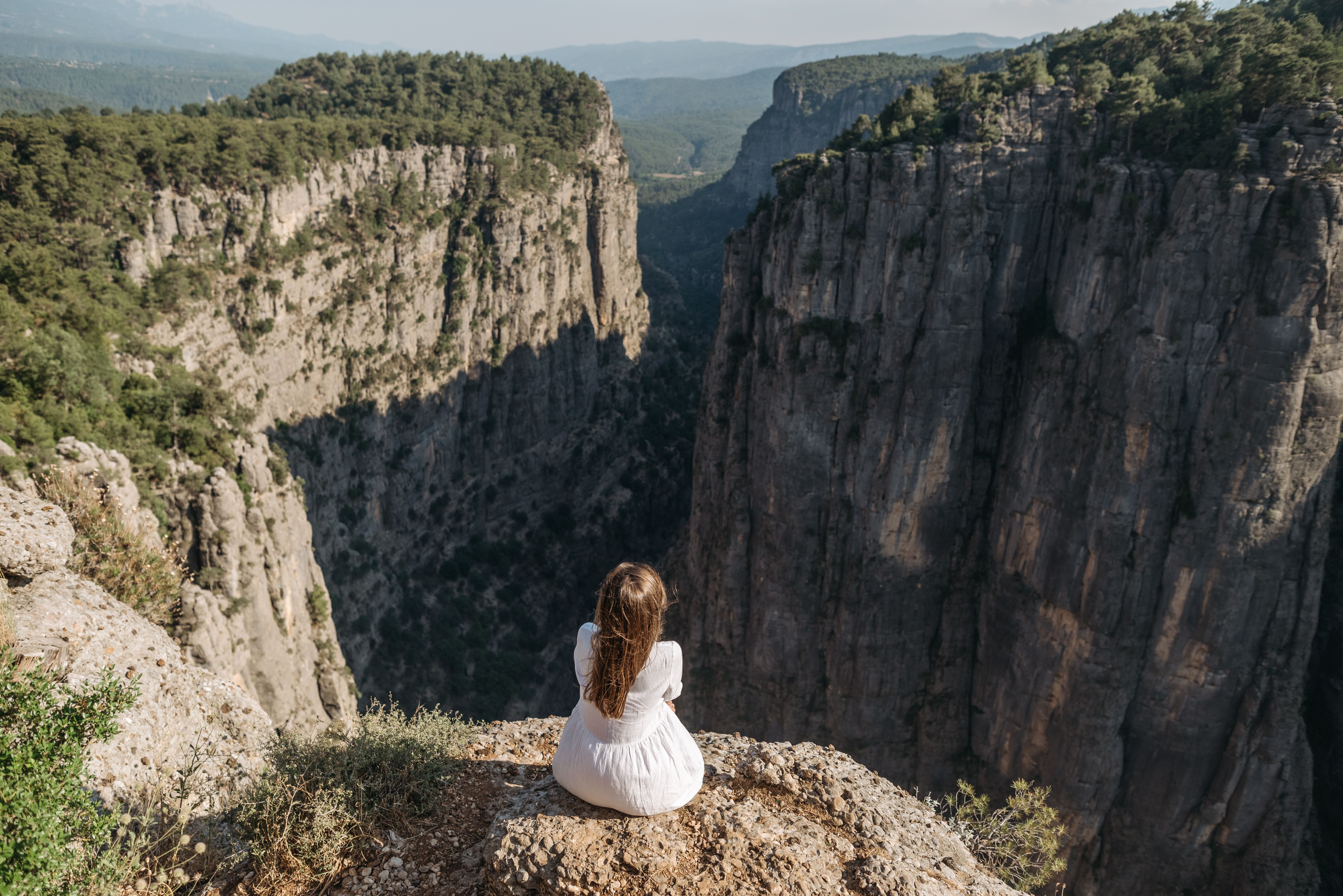 A Woman Sitting on a Cliff · Free Stock Photo