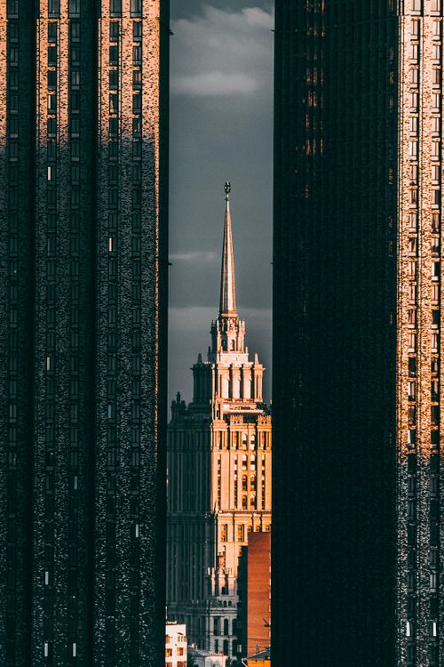 Free A majestic spire framed by modern skyscrapers in urban landscape at twilight. Stock Photo