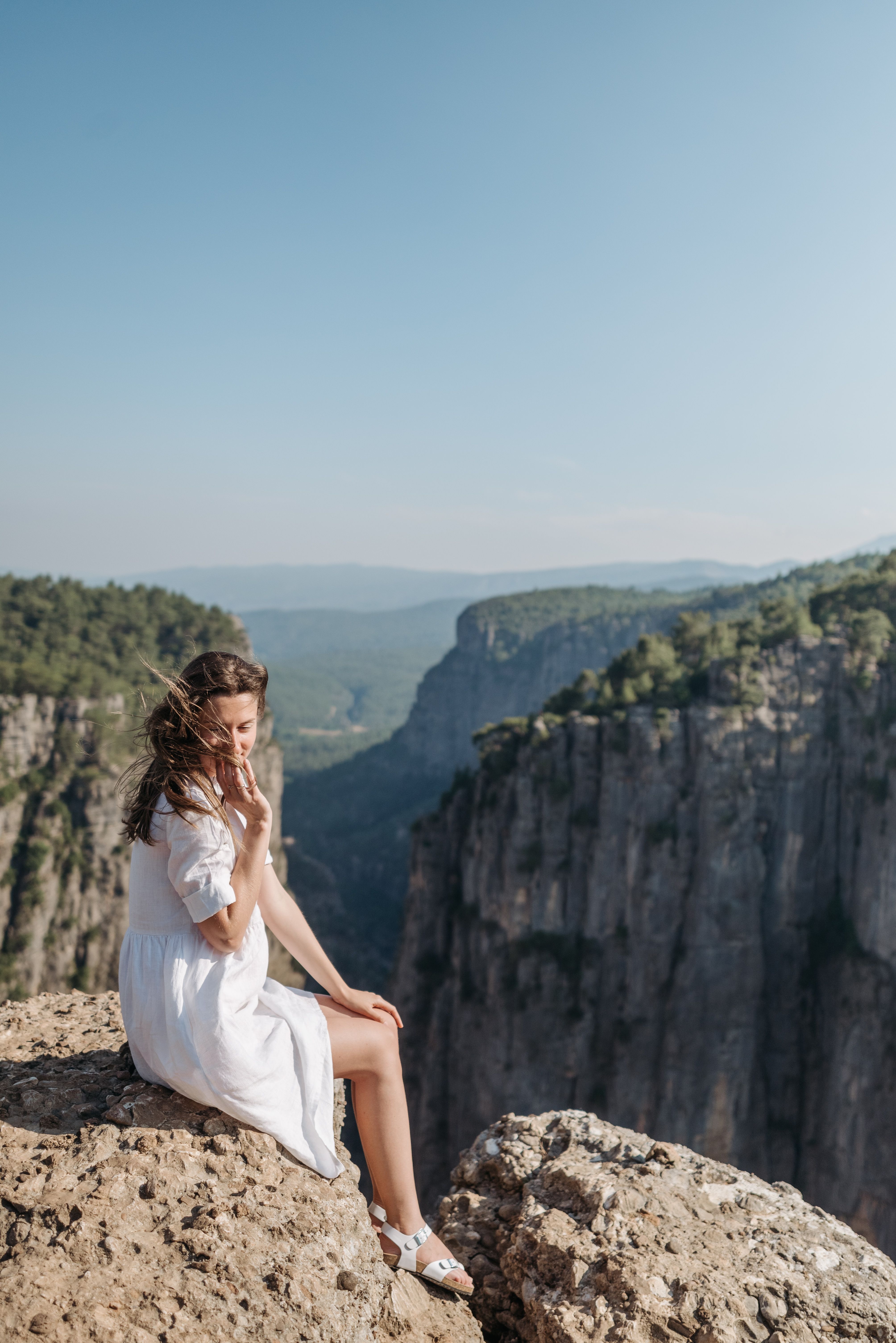 A Woman Sitting on a Rocky Cliff · Free Stock Photo