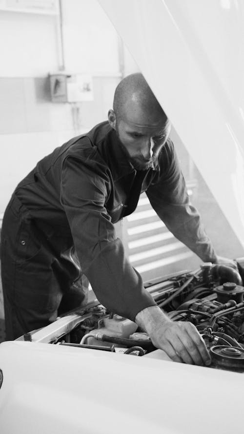 A Mechanic Fixing a Car