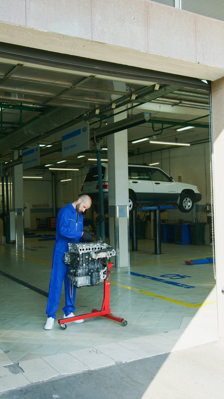 Mechanic Looking At An Engine