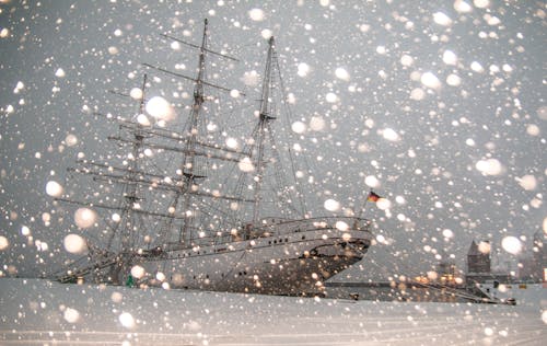 White Sailing Ship Docked at Pier