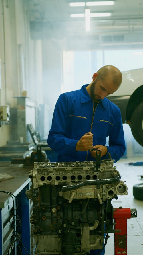 A Mechanic Fixing a Car Engine