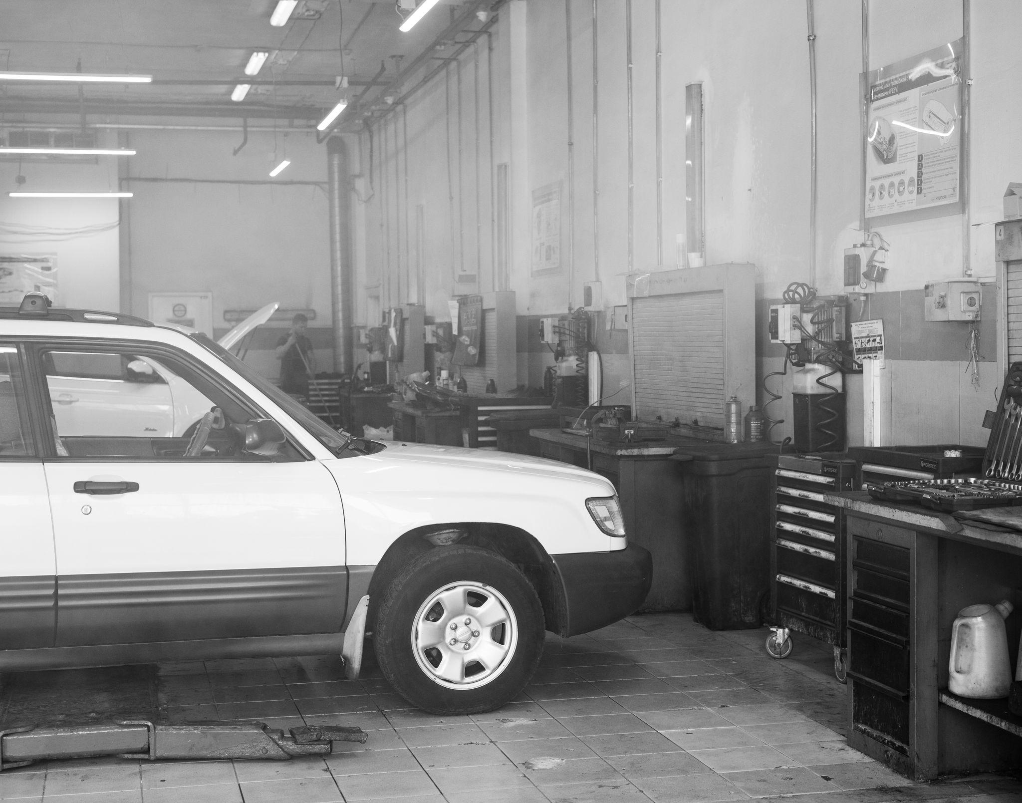 Mechanic working on a car in a garage