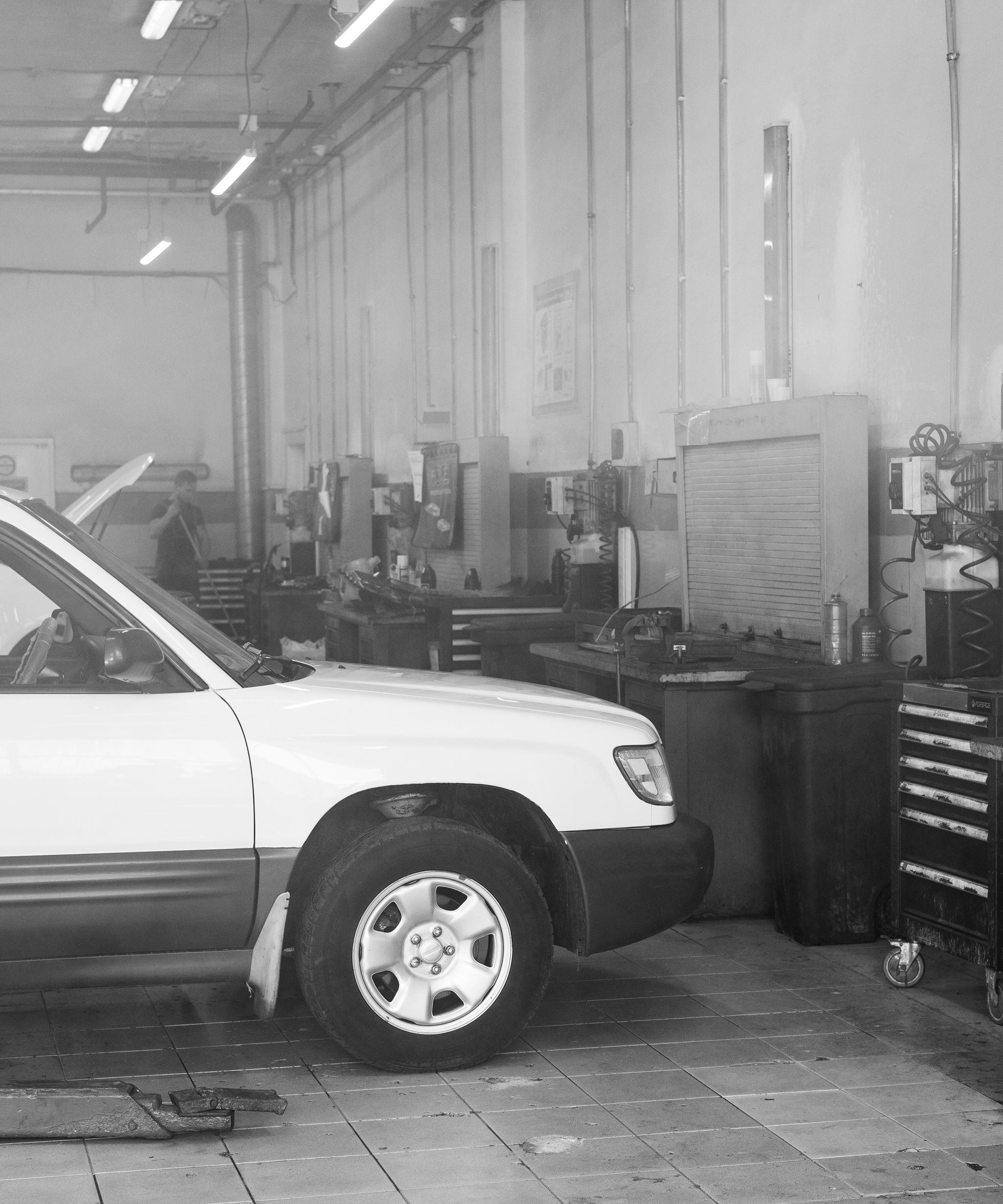 Mechanic working on a car in a garage