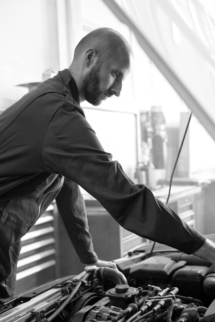 A Mechanic Checking On A Car