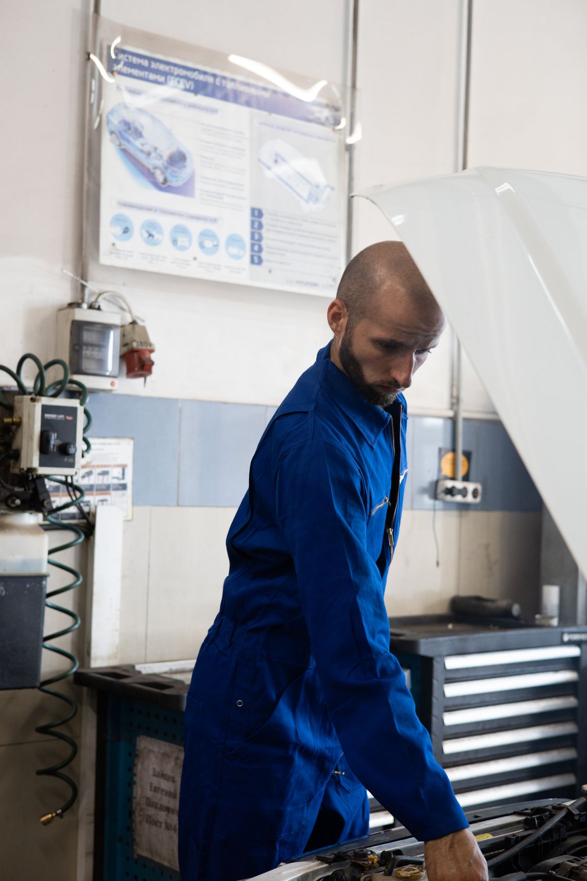 Technician performing engine diagnostics