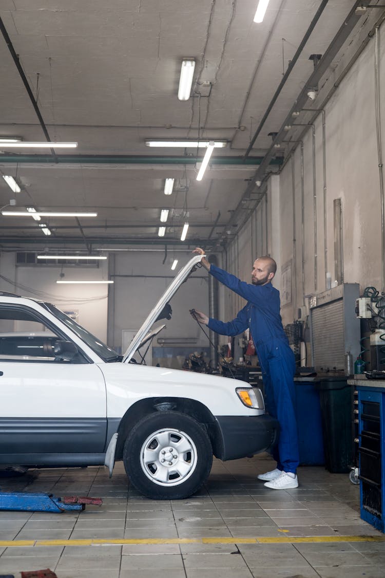 Man Holding A Car Hood