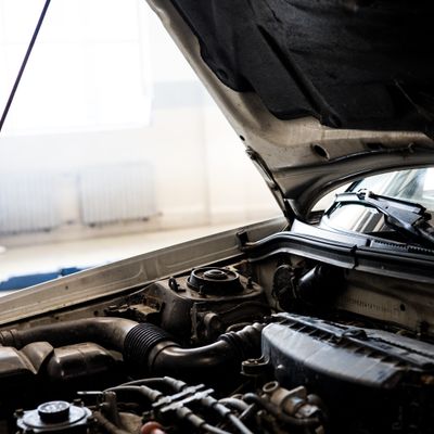 Vehicle engine bay being inspected