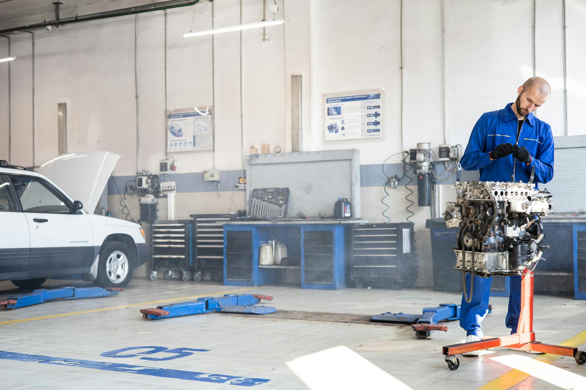 A Mechanic Working on an Engine in an Auto Repair Shop