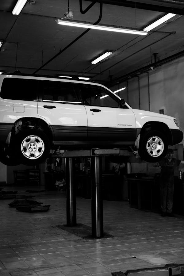 A Motor Vehicle on a Hydraulic Lifter in an Auto Repair Shop