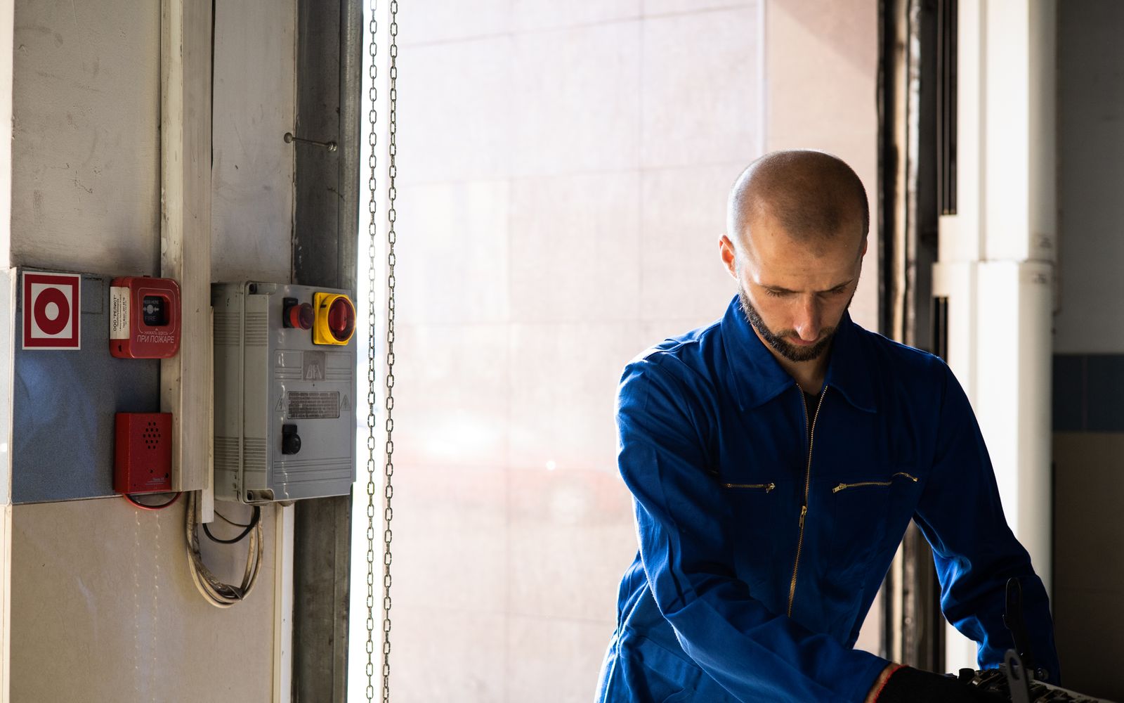 Technician in protective equipment performing planned maintenance