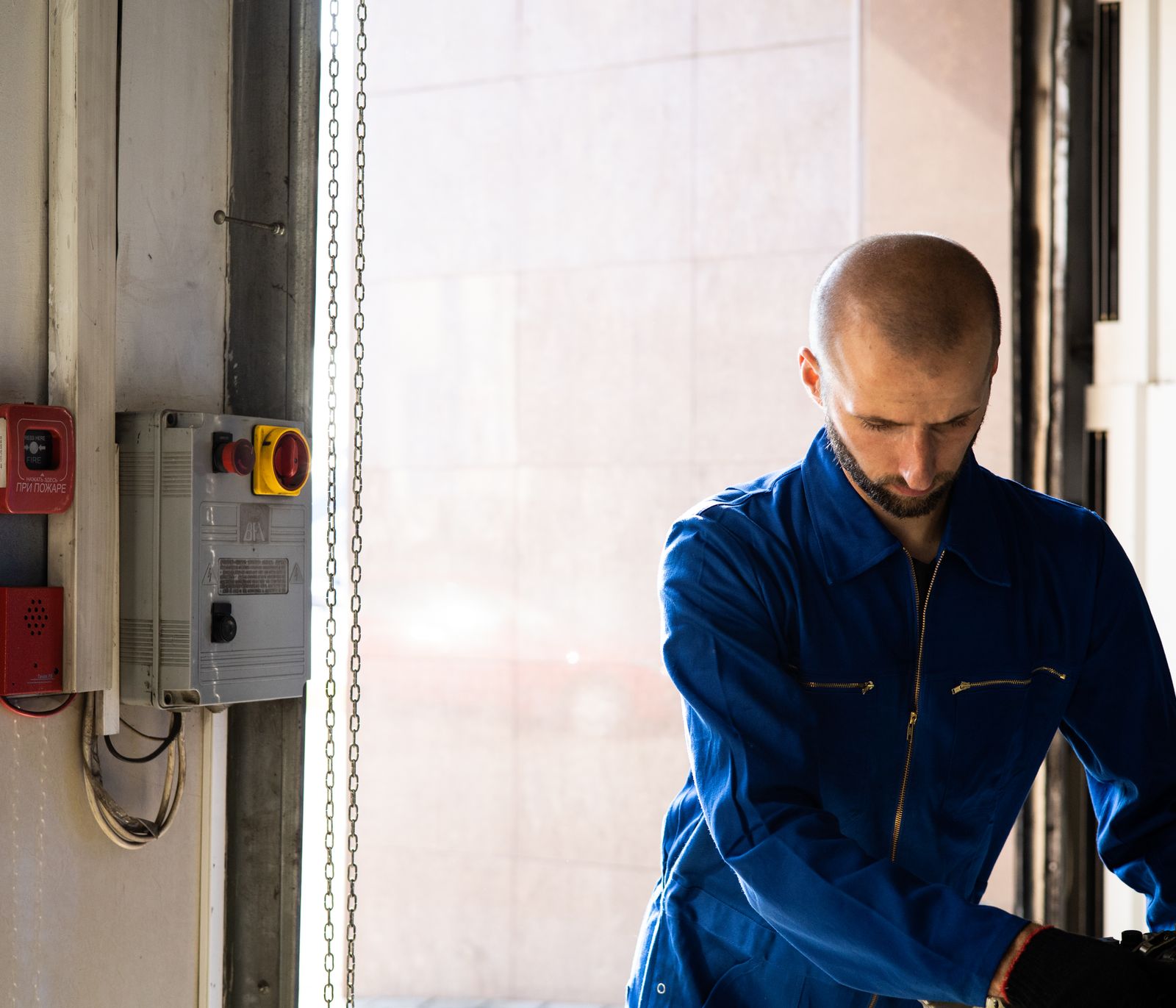 Technician in PPE performing commercial electrical maintenance
