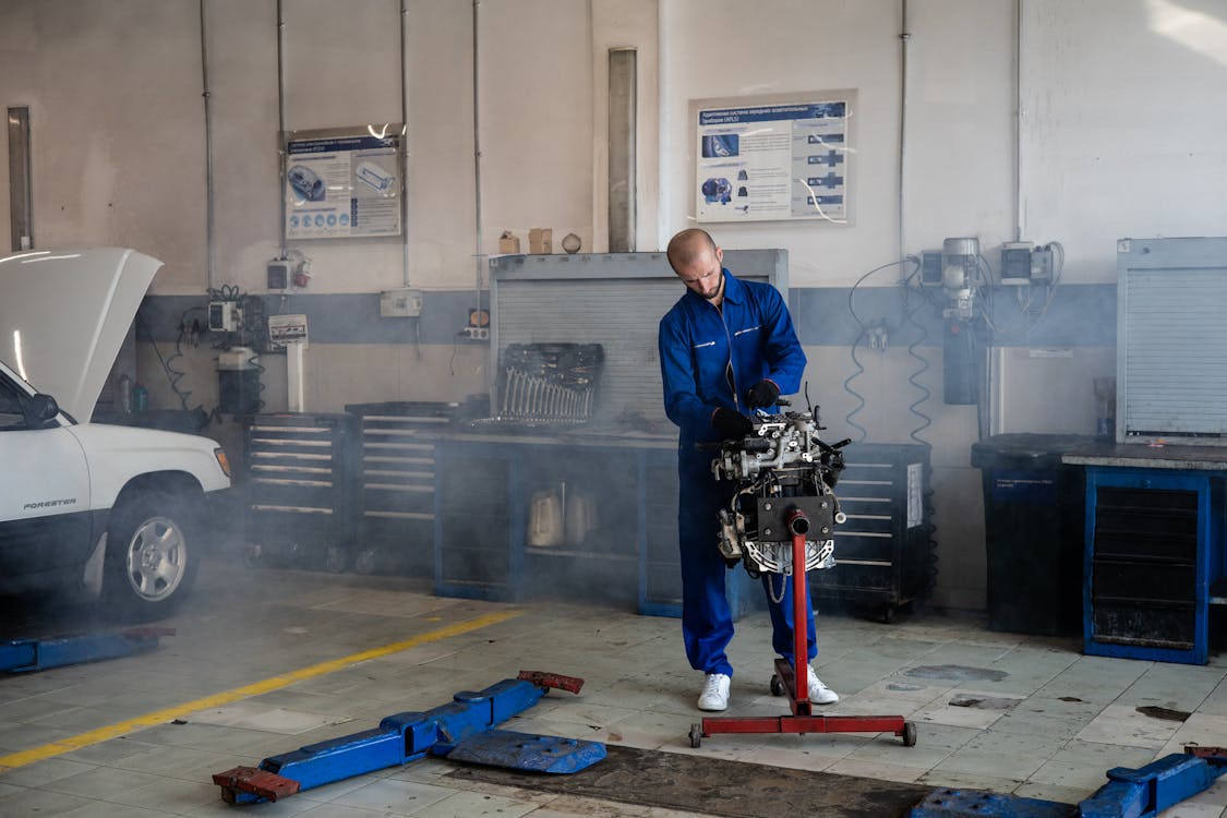 Free A Mechanic Working on a Car Engine Stock Photo