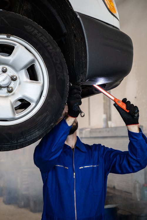 A Mechanic Working on a Car