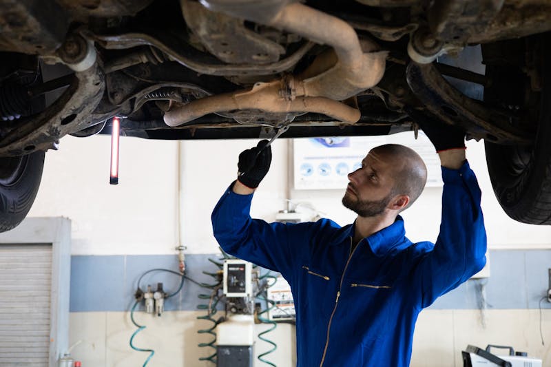 Mechanic inspecting an engine in a professional workshop