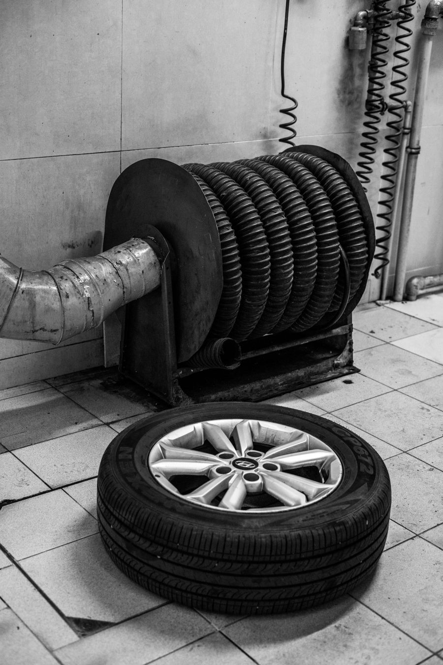 Mechanic working with wheel on car lift