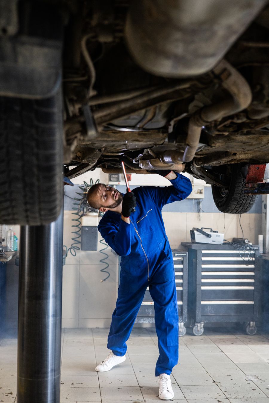 Mechanic in a workshop fixing a car