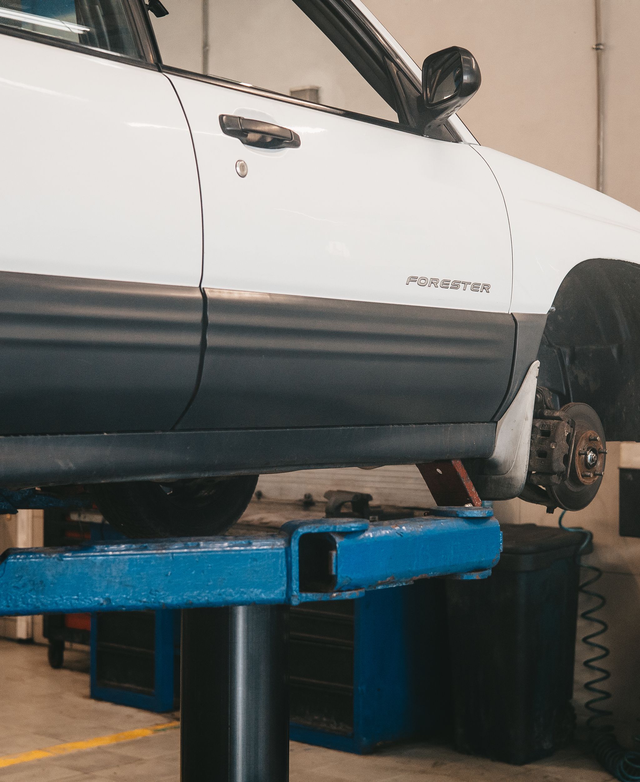 Mechanic working on a car in a garage