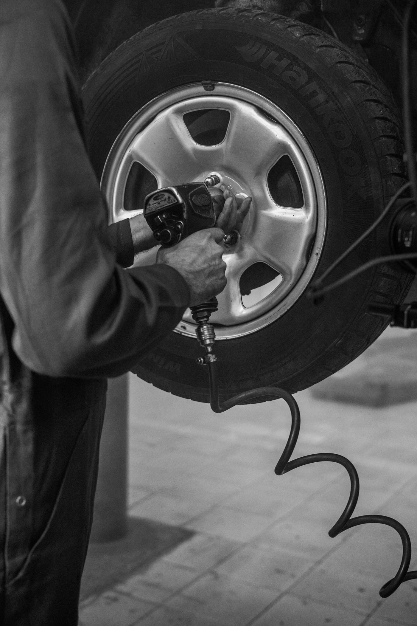 Technician removing a vehicle wheel during tire service