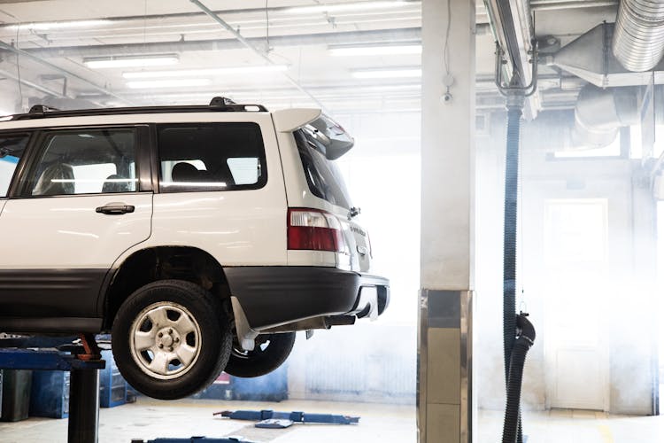 White Car In A Garage For Check Up