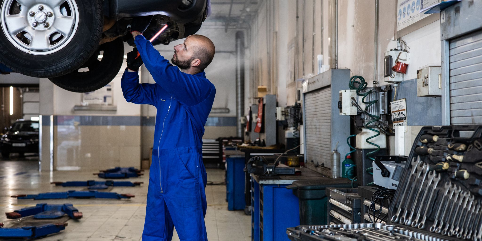Mechanic working on a car in a garage