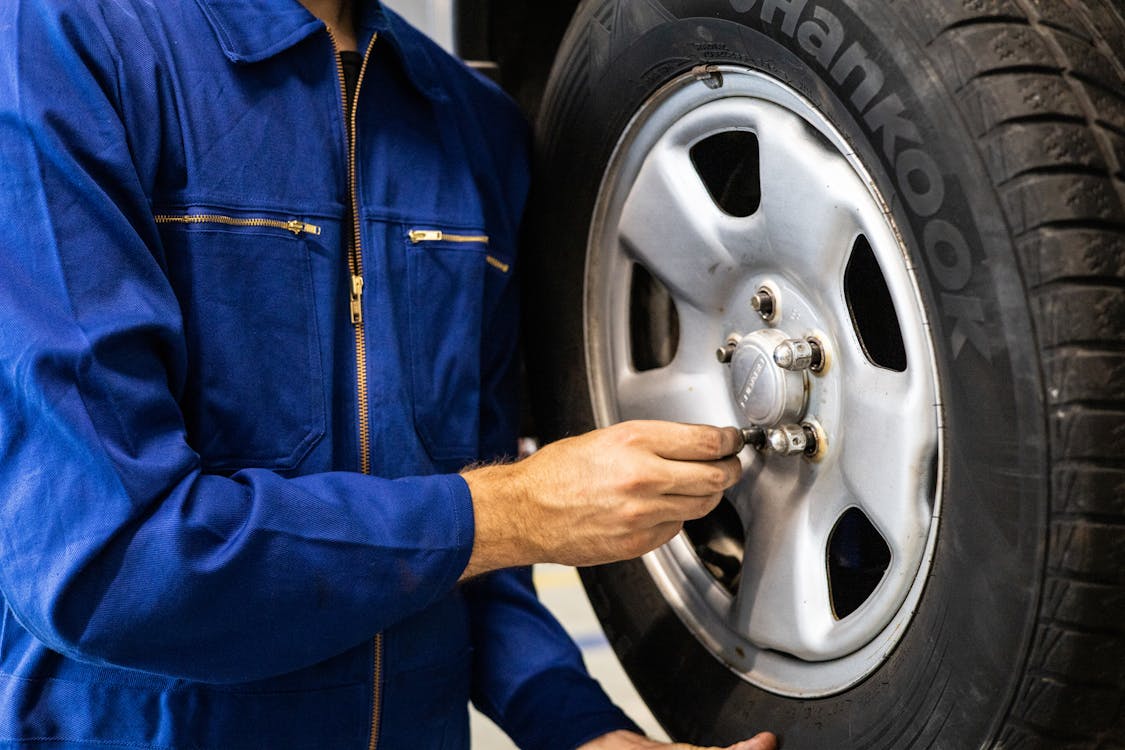 Free A Person Holding a TIre Stock Photo