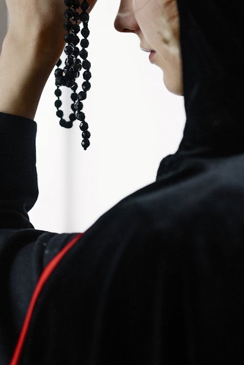 Close-Up Shot of a Person Holding Prayer Beads