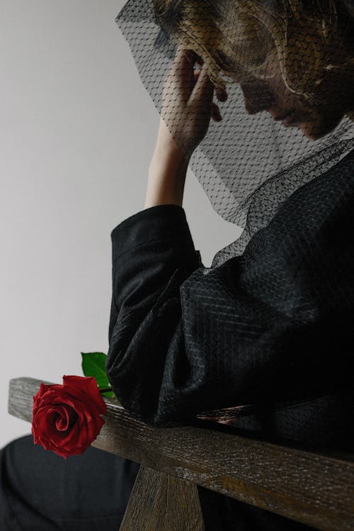 Profile of a Grieving Widow, Wearing a Black Veil, and Holding a Red Rose