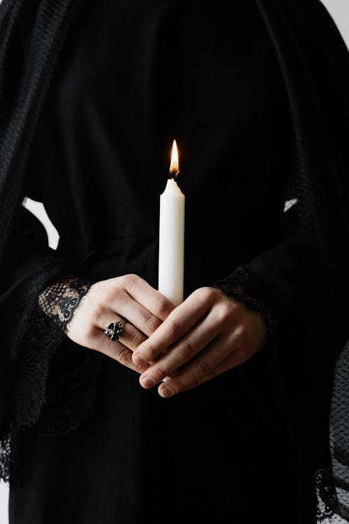 Person Holding a Burning Candle