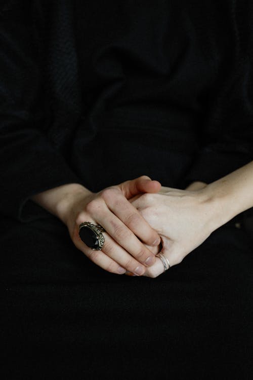Person Wearing Ring With Black Gemstone