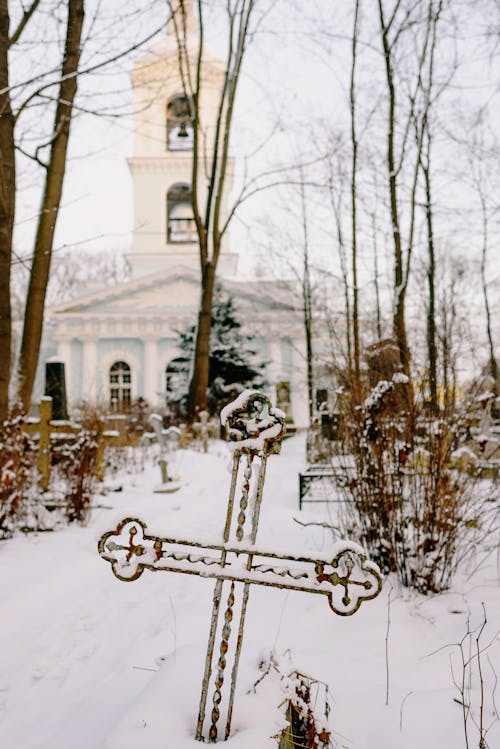 Cemetery in Front of a Church in Winter 