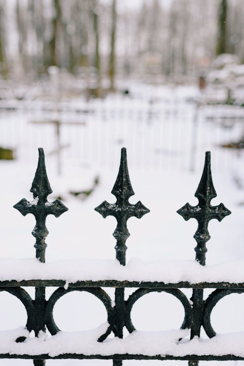 Snow Covered Black Metal Fence 