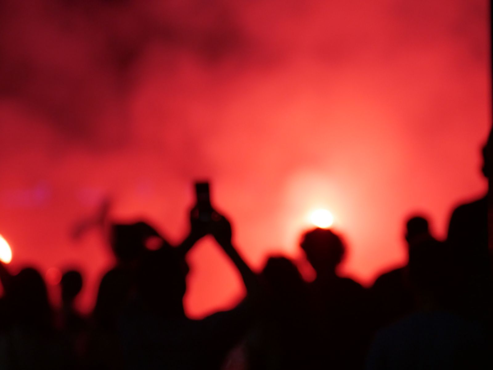 Silhouettes of a crowd against red smoke — photo by Emanuele Intagliata on Pexels