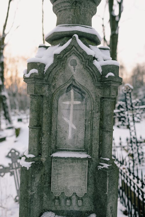 A Concrete Tombstone Covered with Snow