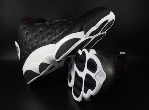 Free Close-up image of stylish black and white sneakers on a black surface. Stock Photo